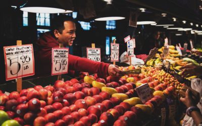 man selling produce at farmer's market